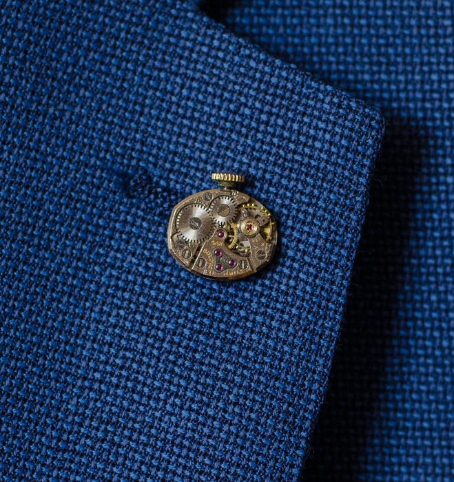steampunk lapel pin on blue suit