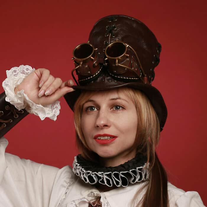 Woman wearing a steampunk costume and a hat