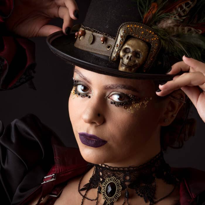 Emotional Portrait of Young Woman in Steampunk or Retro style. Studio shot. Model on a Black Background