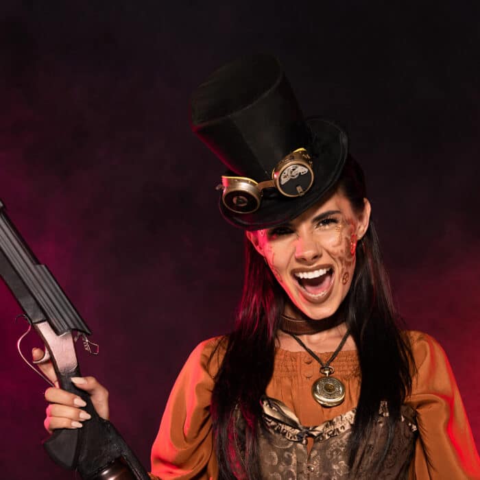 Front view of screaming steampunk woman holding gun and pistol in pink smoke on black