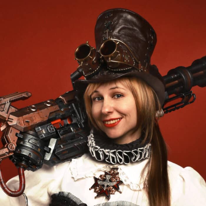 Steampunk woman holding weapon red background