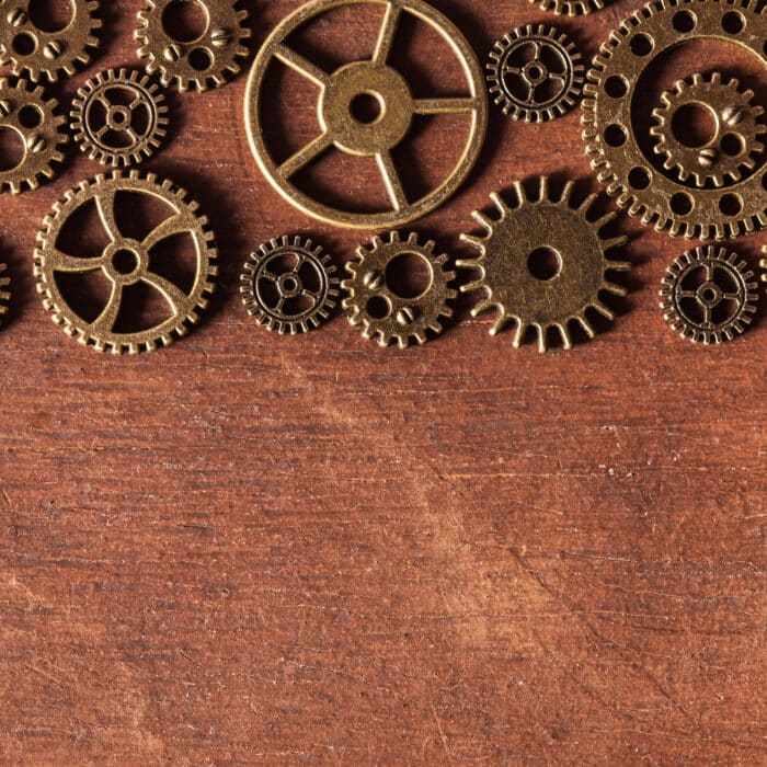 Steampunk mechanical cogs gears wheels on wooden background