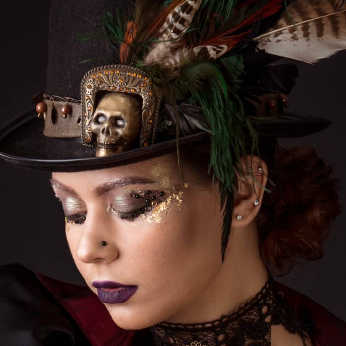 Emotional Portrait of Young Woman in Steampunk or Retro style. Studio shot. Model on a Black Background